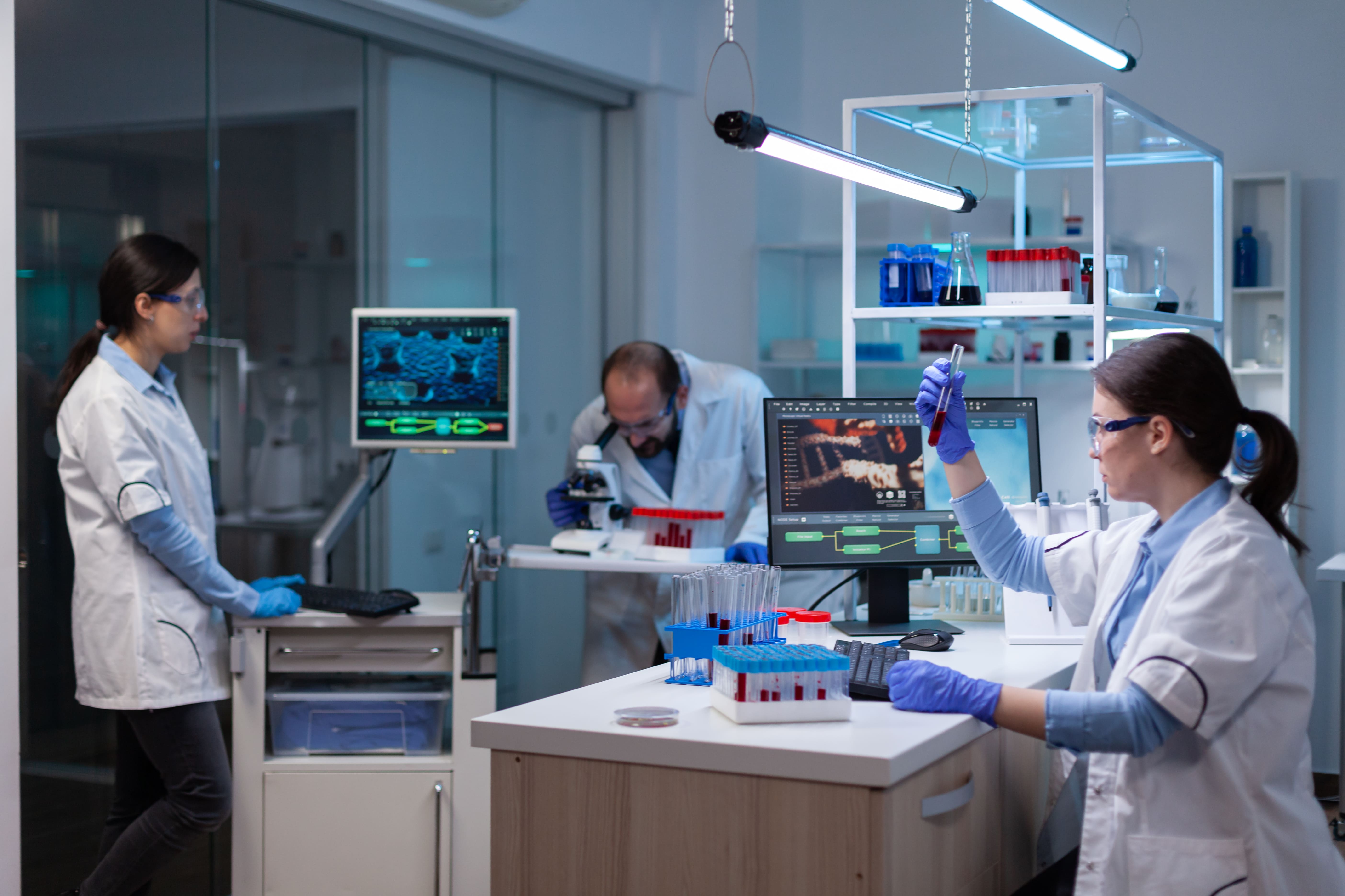 A pharmaceutical research team in a lab.